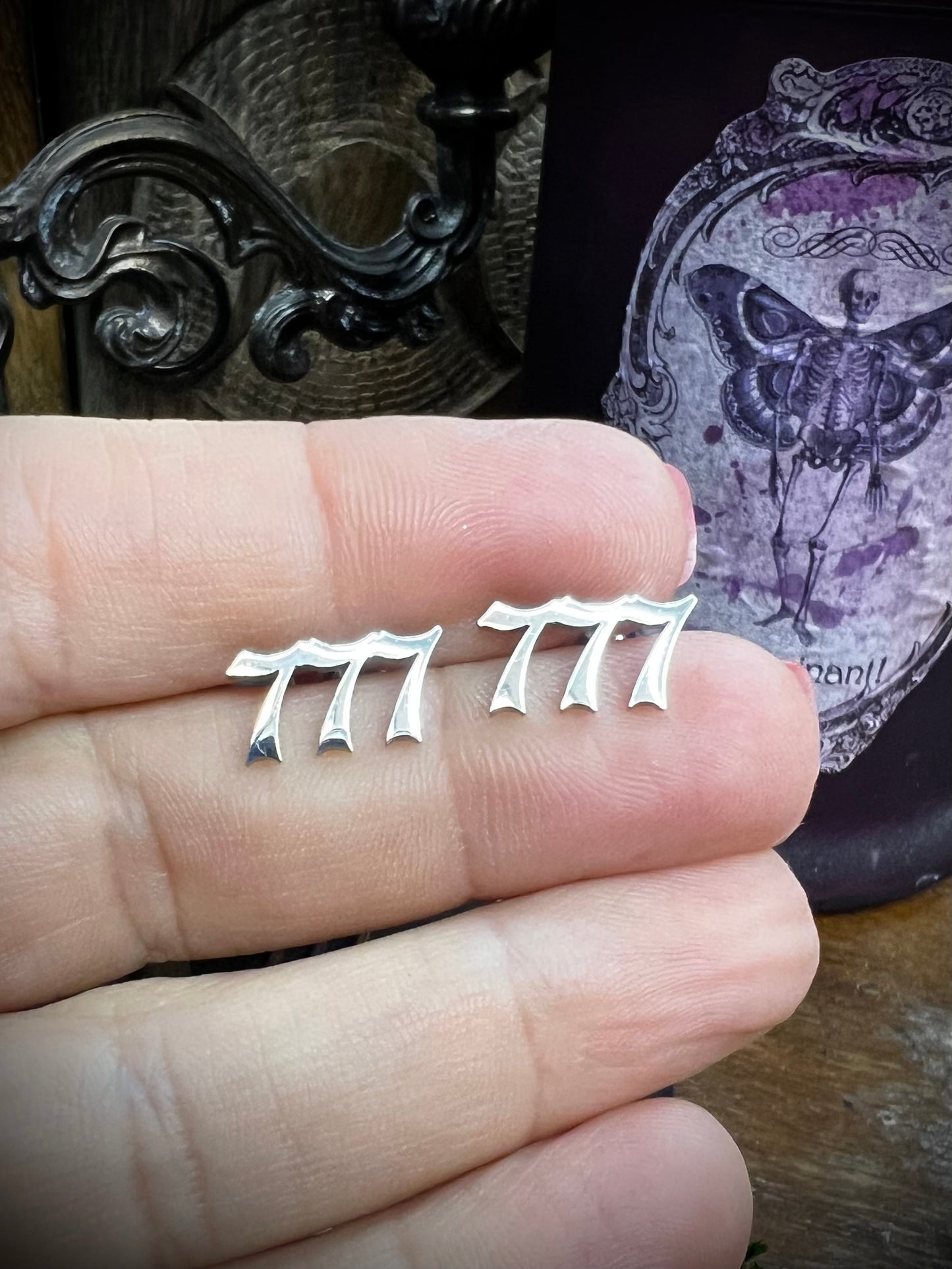 Numerology 777 stud earrings with magical background
