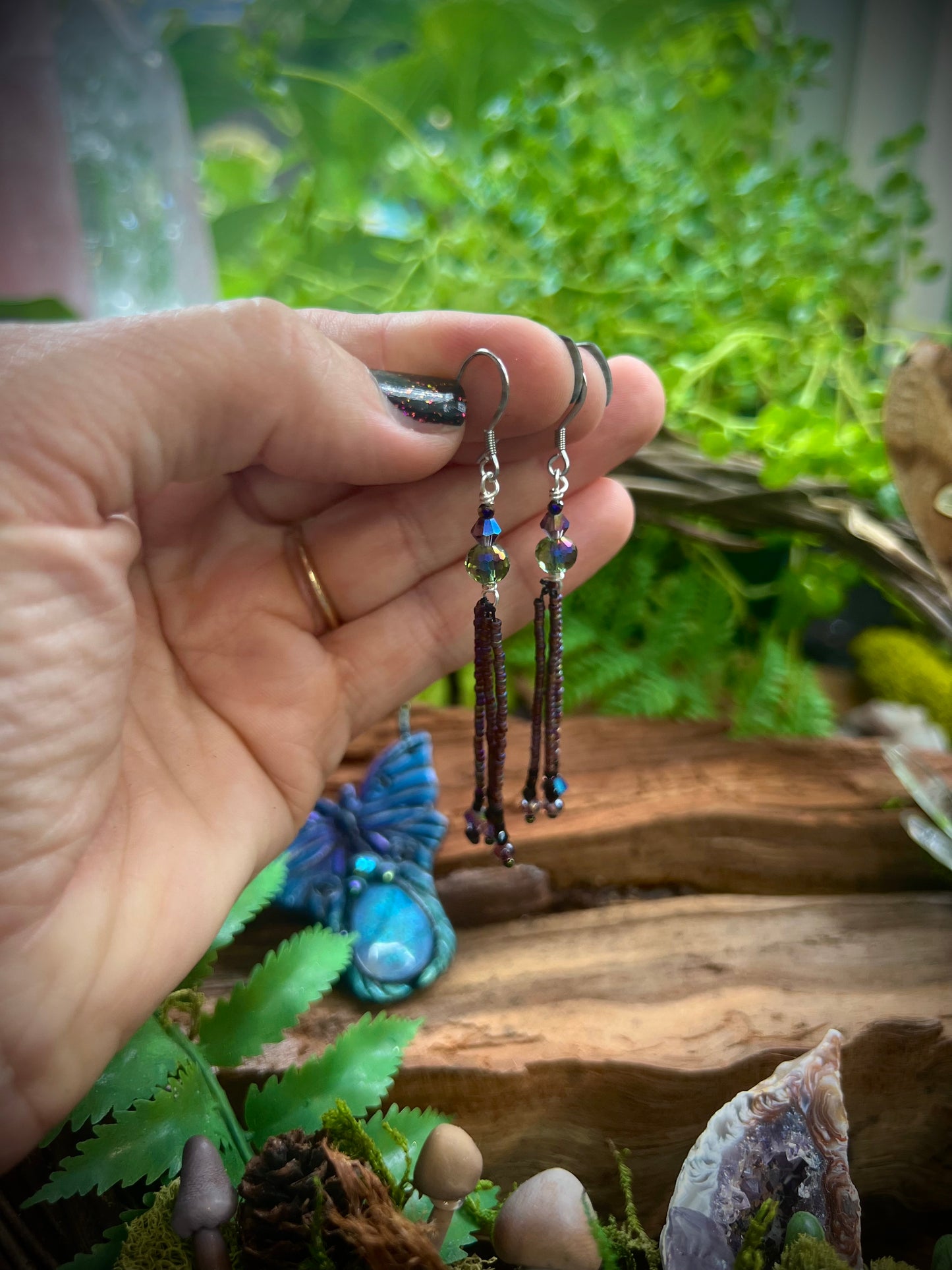Artisan crystal and seed bead tassel earrings shimmering in natural light