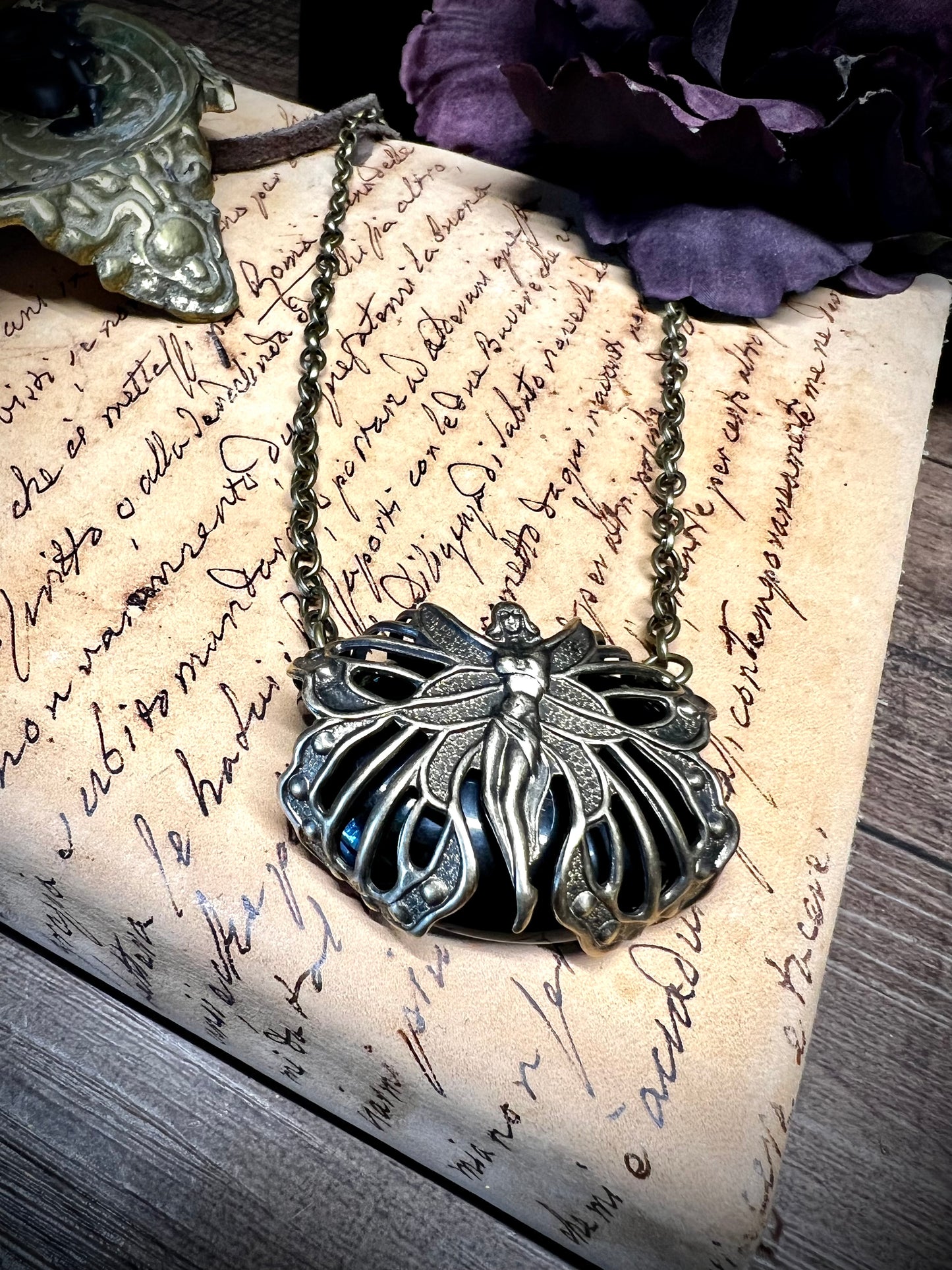 Oval obsidian pendant necklace with antique victorian filigree moth wrap