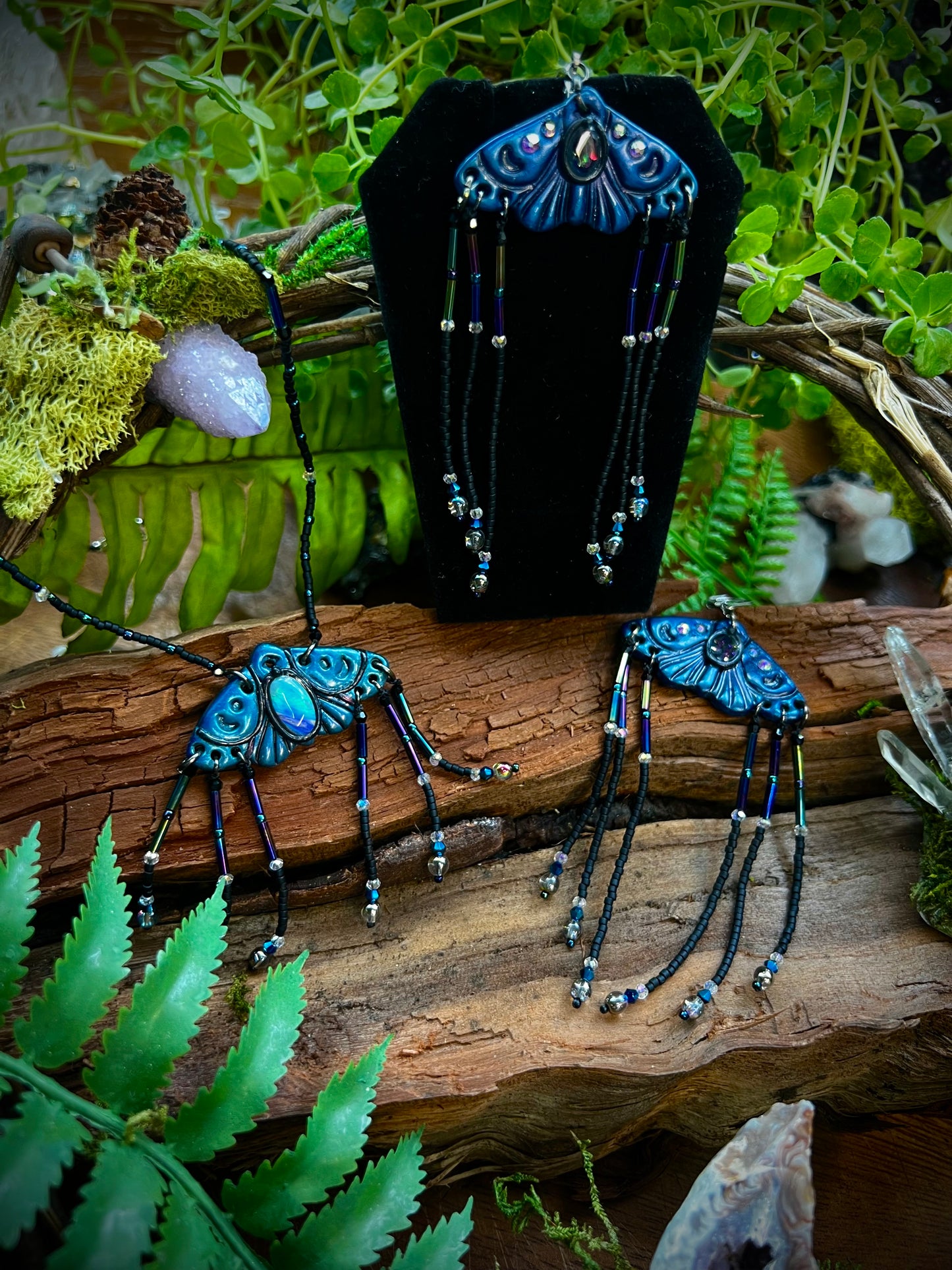 Enchanted fairycore moth earrings and necklace styled among ferns and natural wood