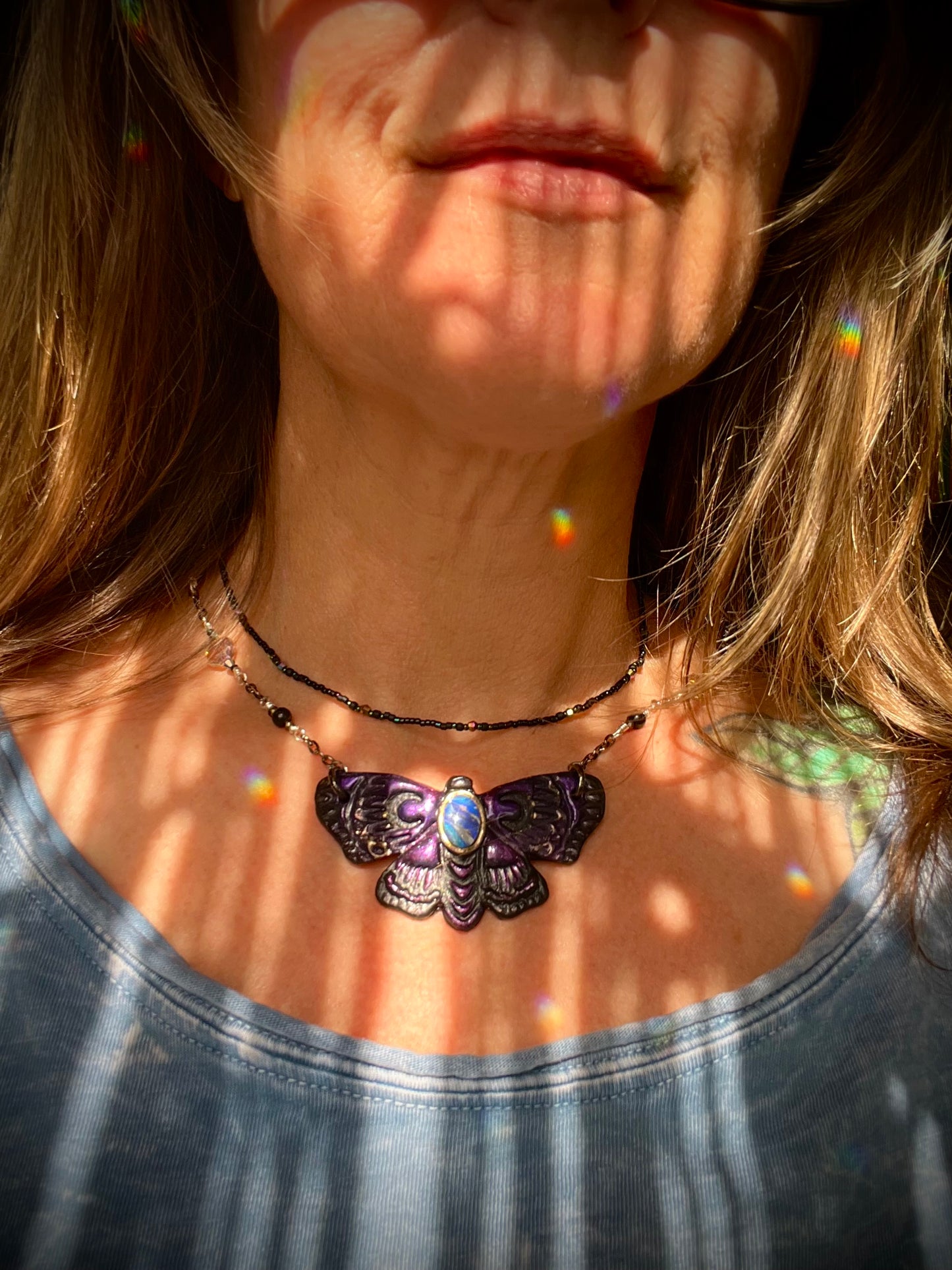 Handcrafted moth pendant necklace symbolizing protection, creativity, and clarity