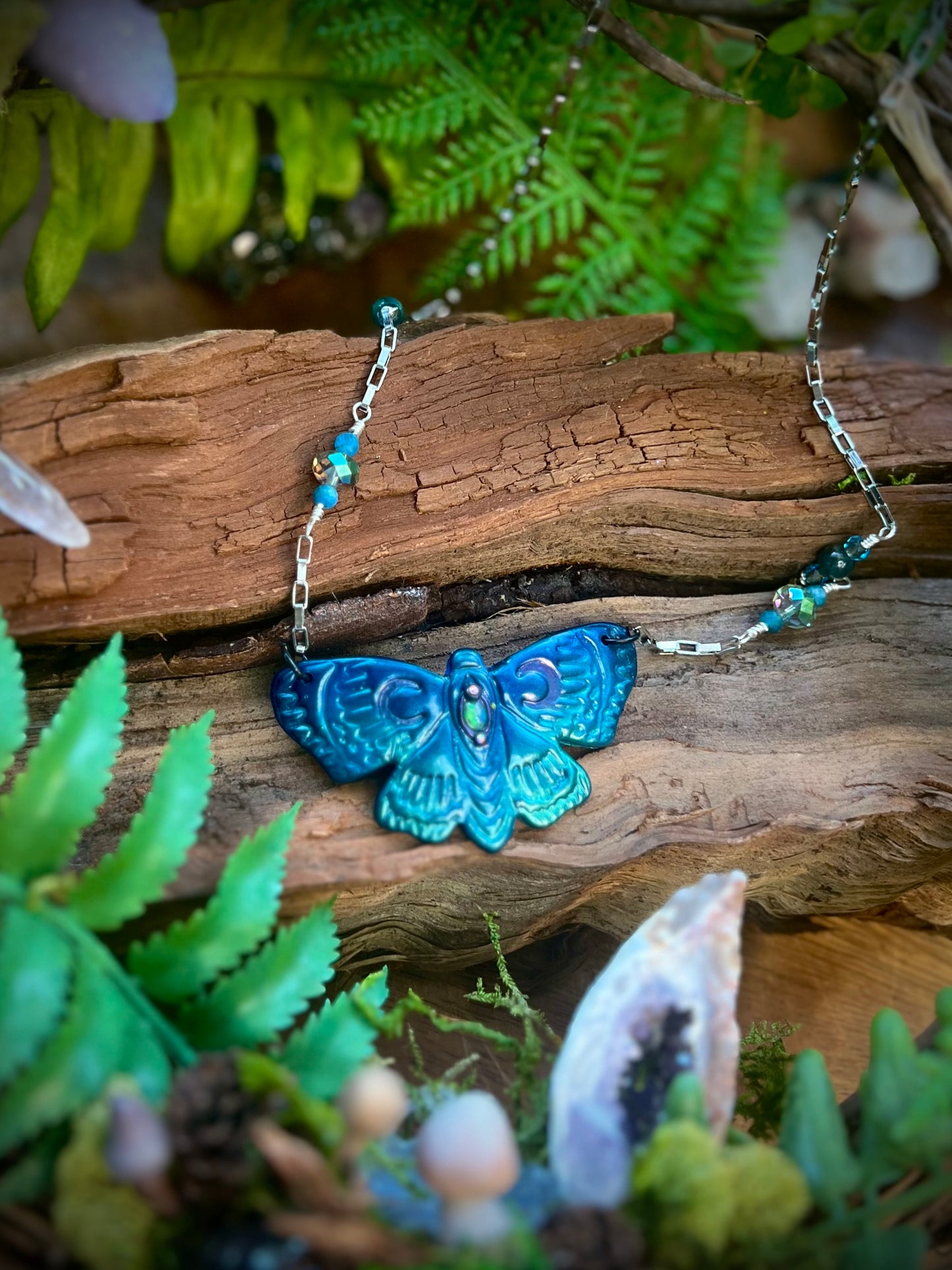Moonlit moth pendant necklace styled in forest-inspired setting