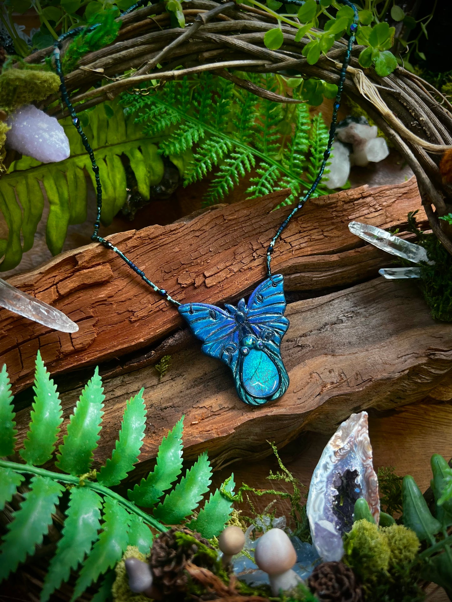Australian opal centerpiece glowing in handcrafted luna moth pendant