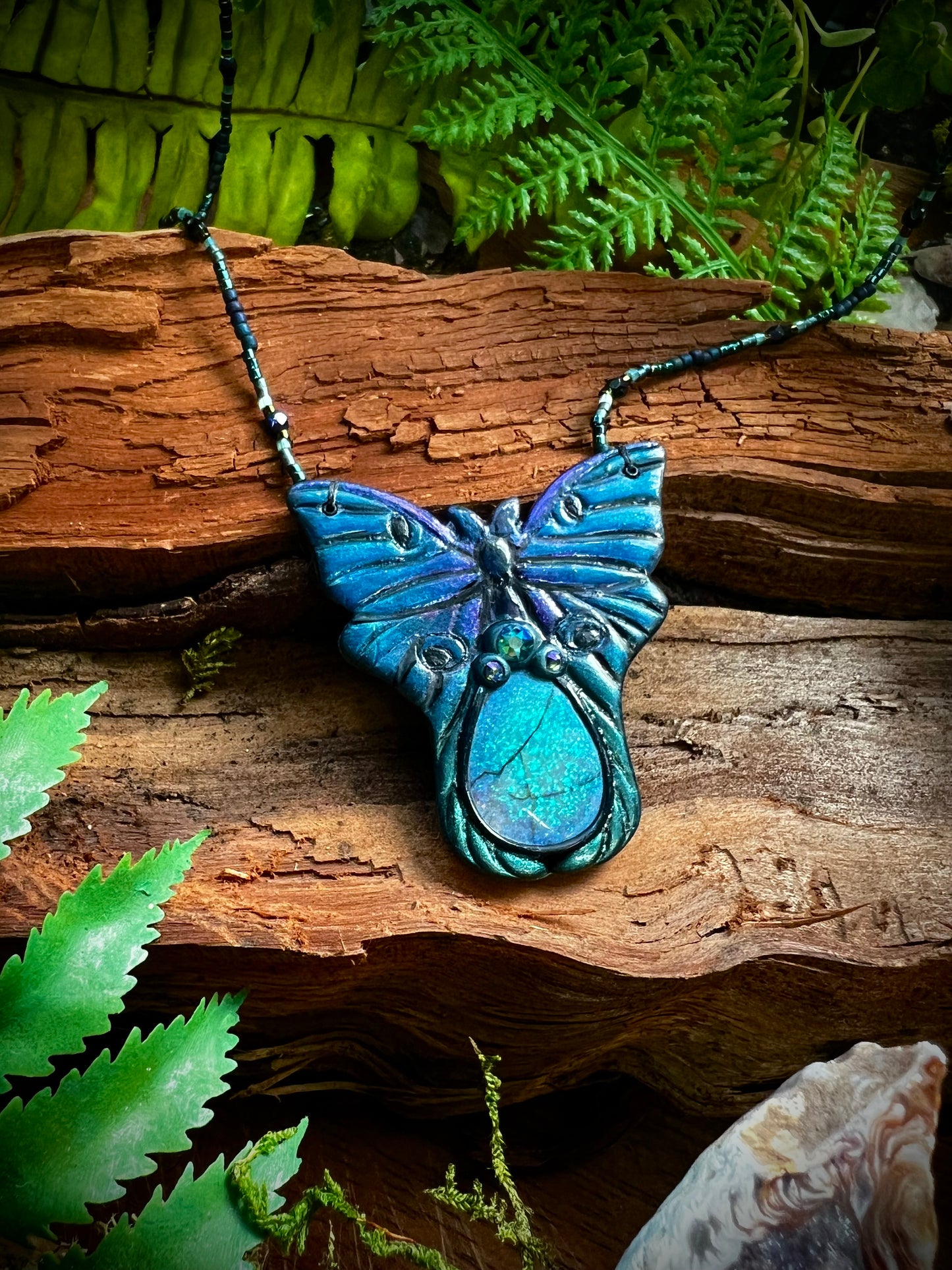 Enchanted opal moth necklace symbolizing transformation and intuition