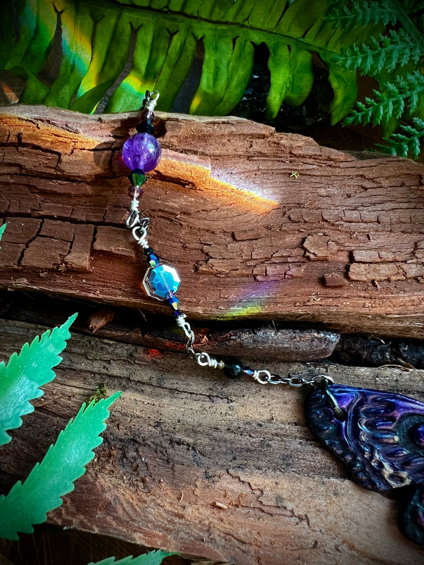 Opal moth statement necklace glowing in natural light with crystal accents