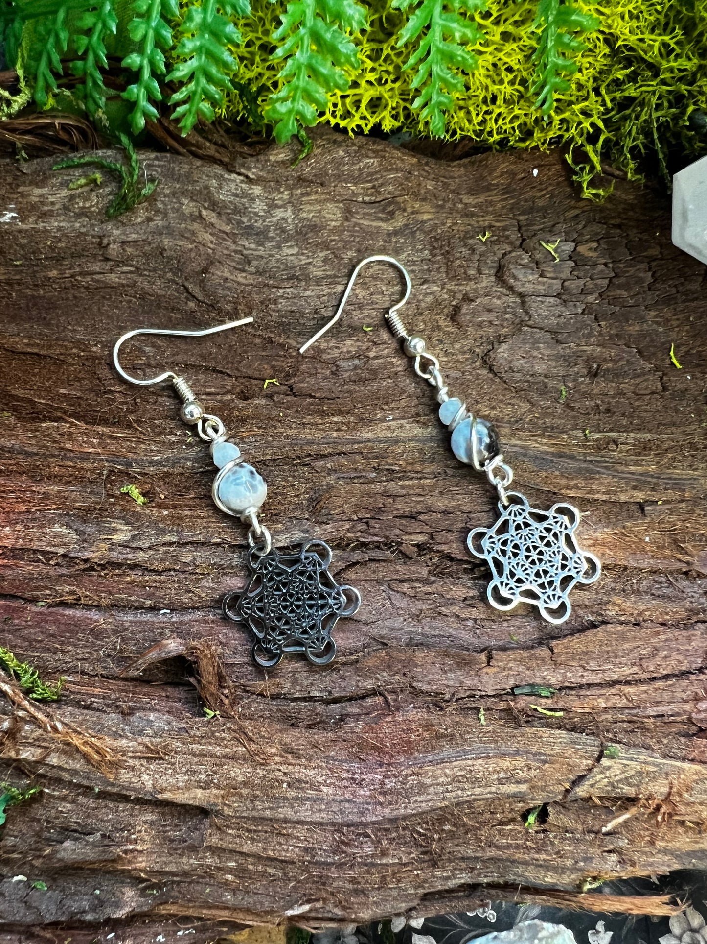 Grounding agate Metatron earrings with sacred geometry charms styled on moss and wood
