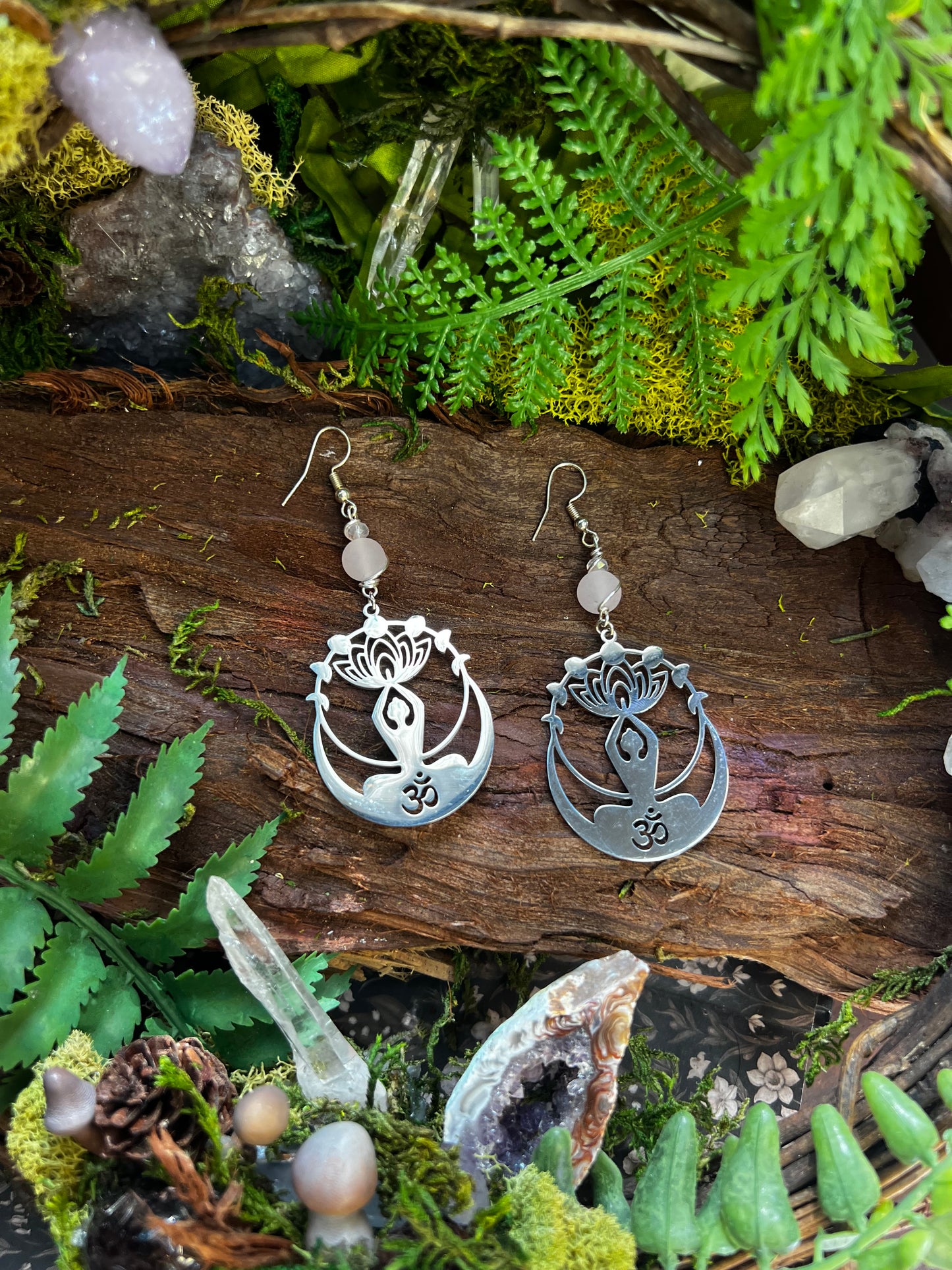 Yoga-inspired mystical earrings styled with greenery, crystals, and serene forest vibes