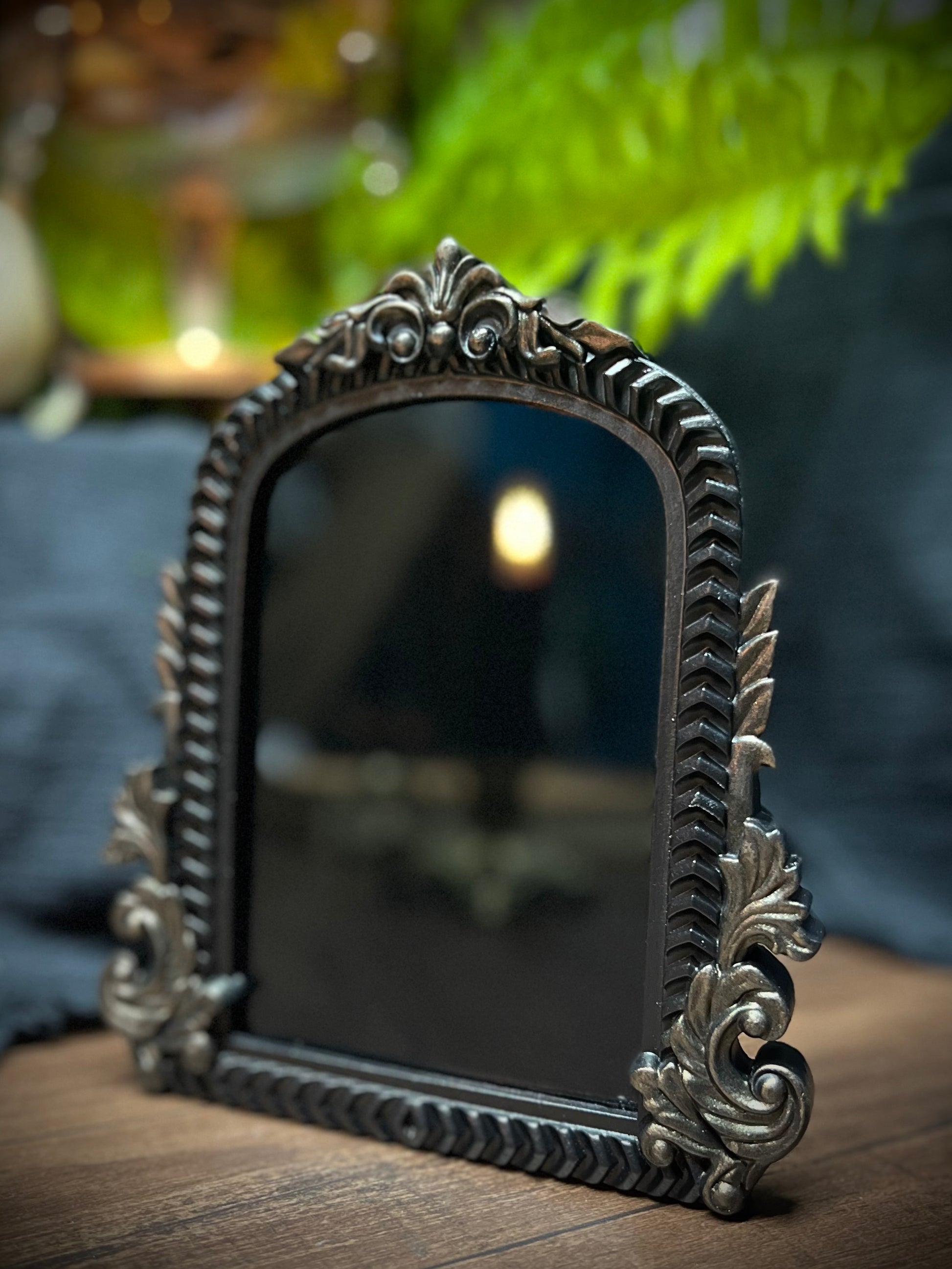 Small Fancy Black Scrying Mirror Ornate Scrolls Black and Bronze Detail on a Witch’s Altar Divination Magickal Mirror