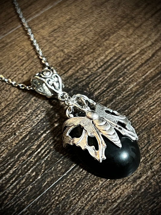 Oval obsidian pendant necklace with antique victorian filigree moth wrap