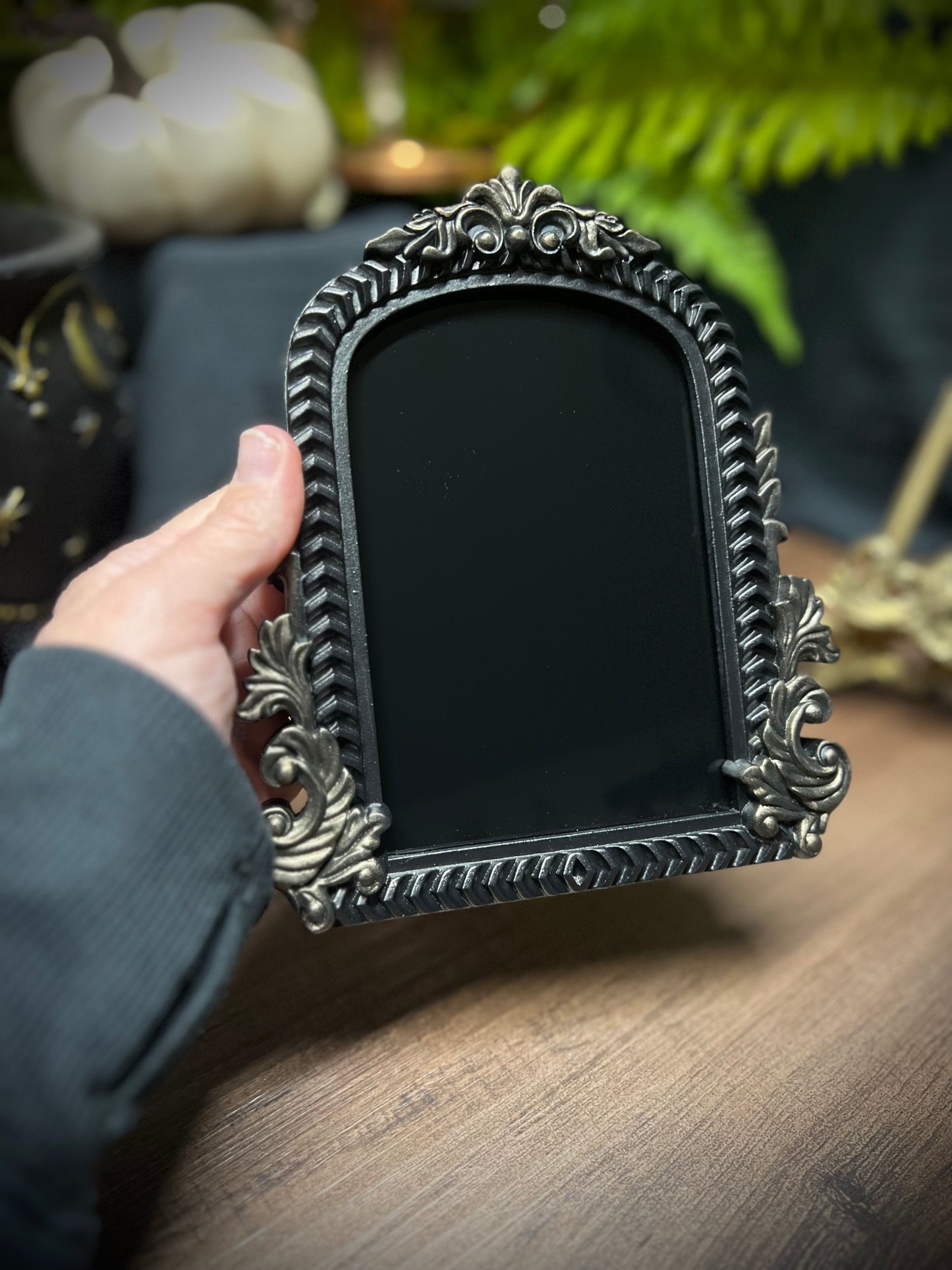 Small Fancy Black Scrying Mirror Ornate Scrolls Black and Bronze Detail on a Witch’s Altar Divination Magickal Mirror