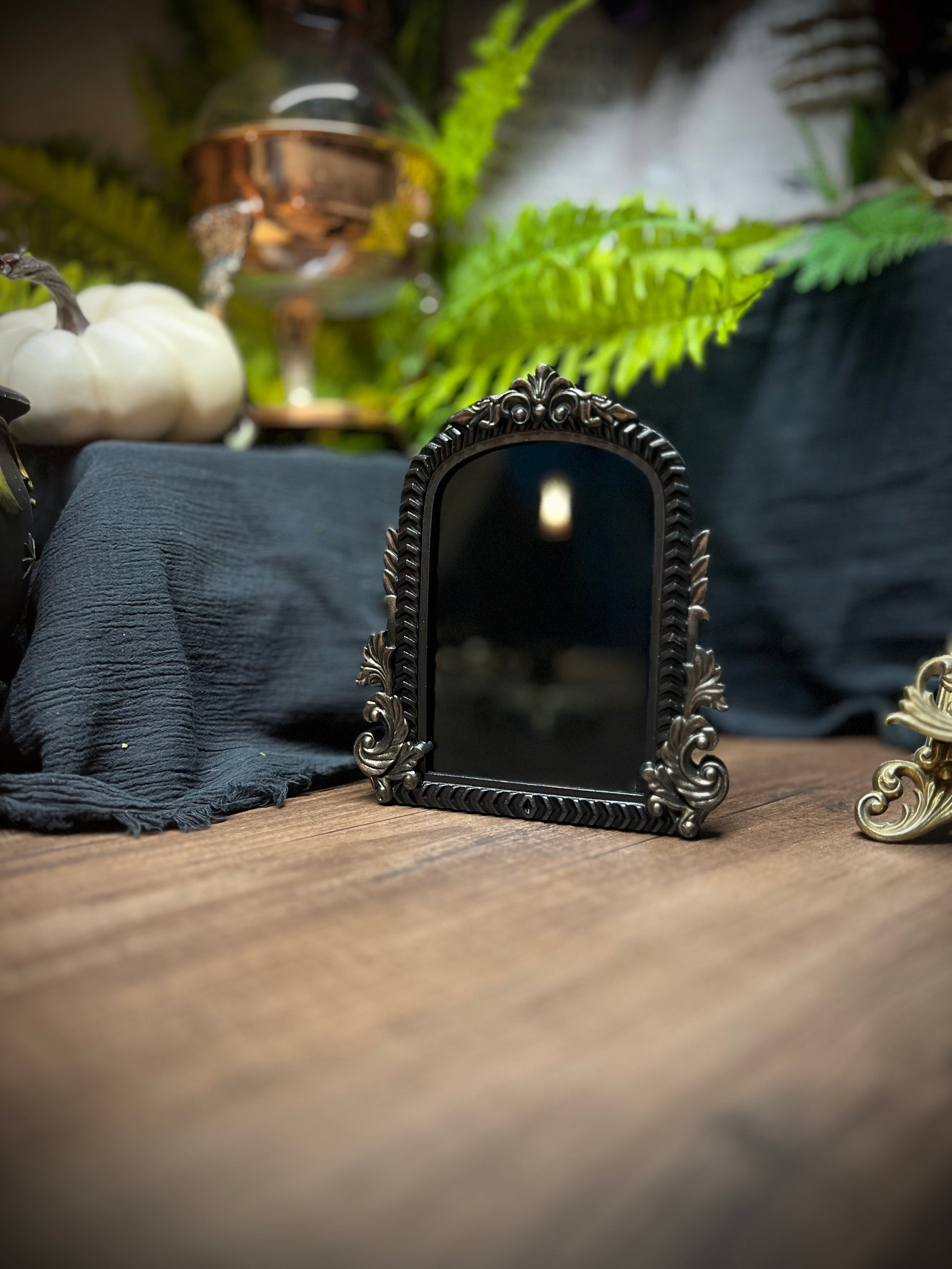 Small Fancy Black Scrying Mirror Ornate Scrolls Black and Bronze Detail on a Witch’s Altar Divination Magickal Mirror