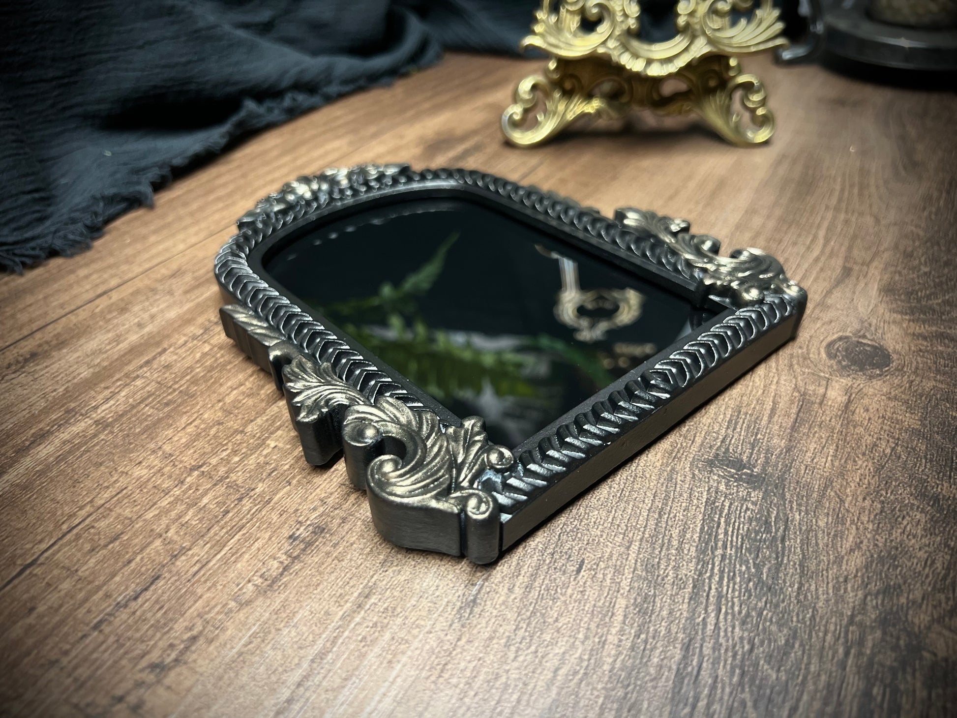 Small Fancy Black Scrying Mirror Ornate Scrolls Black and Bronze Detail on a Witch’s Altar Divination Magickal Mirror
