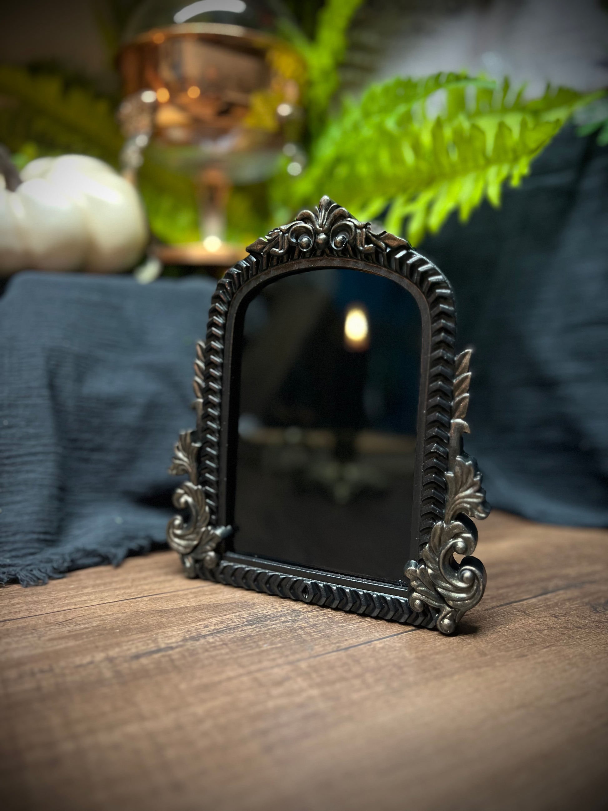 Small Fancy Black Scrying Mirror Ornate Scrolls Black and Bronze Detail on a Witch’s Altar Divination Magickal Mirror