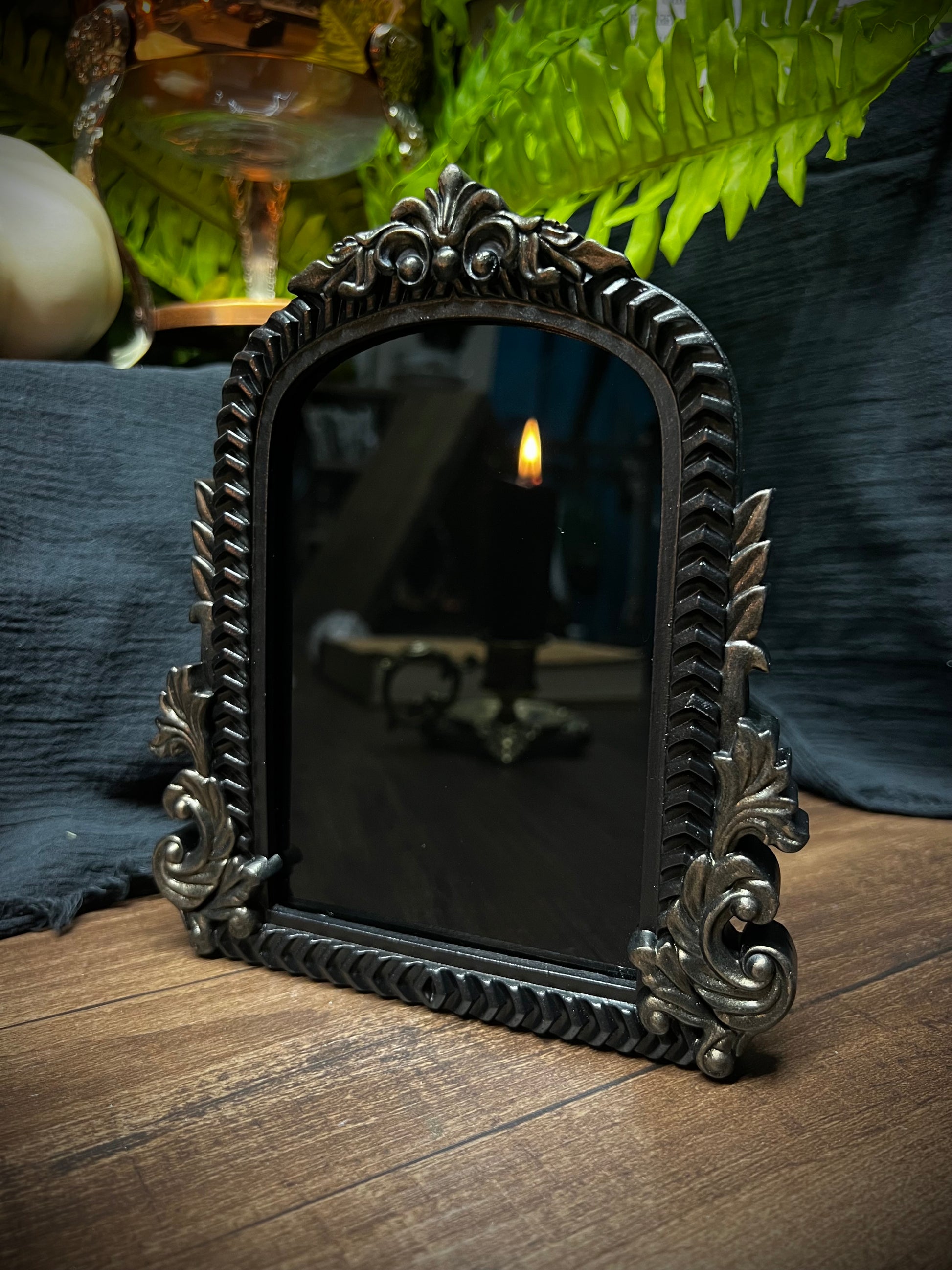 Small Fancy Black Scrying Mirror Ornate Scrolls Black and Bronze Detail on a Witch’s Altar Divination Magickal Mirror