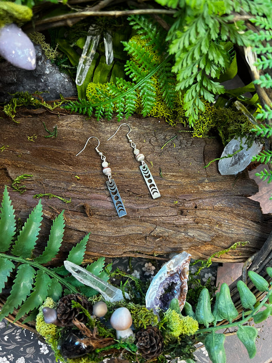 Rhodochrosite and Moonstone moon phase earrings on wood background