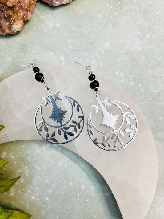 “Witchy triple moon dangle earrings with black onyx beads and silver crescent design”
