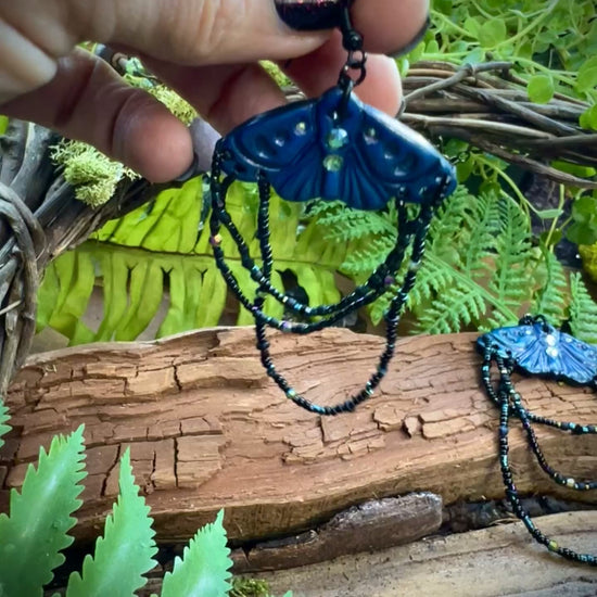 Hand-sculpted polymer clay moth earrings with crescent moon wing details