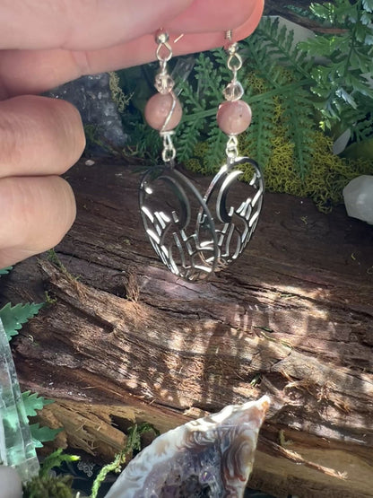 Pink crystal and moon earrings styled with greenery and wood, symbolizing self-expression