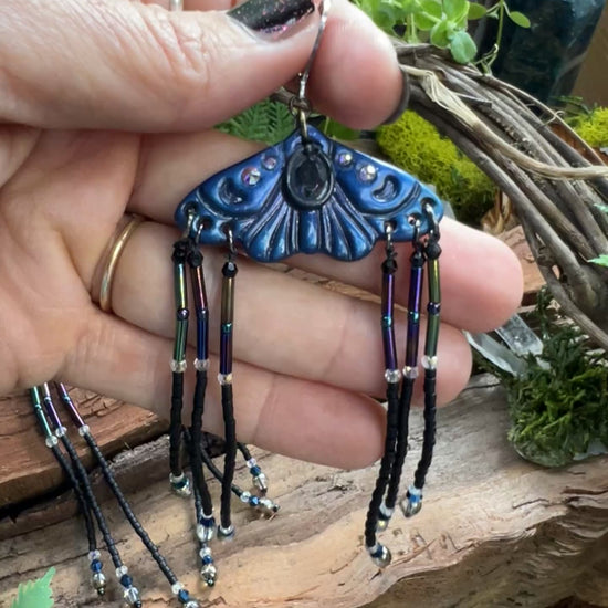 video of moth earrings with flowing seed bead fringe and iridescent crystal accents