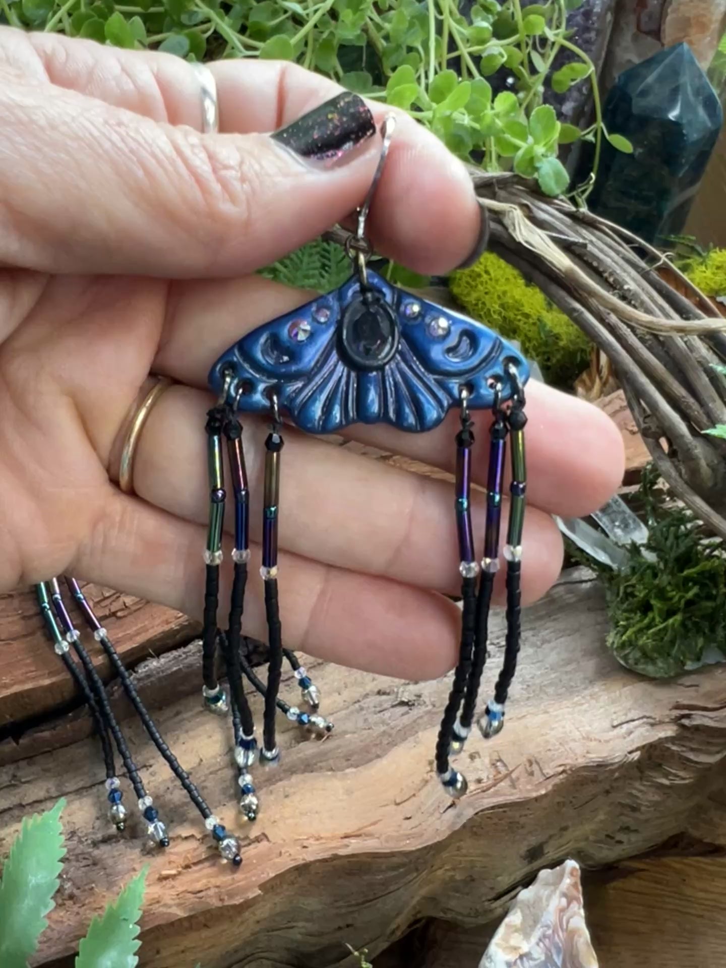 video of moth earrings with flowing seed bead fringe and iridescent crystal accents