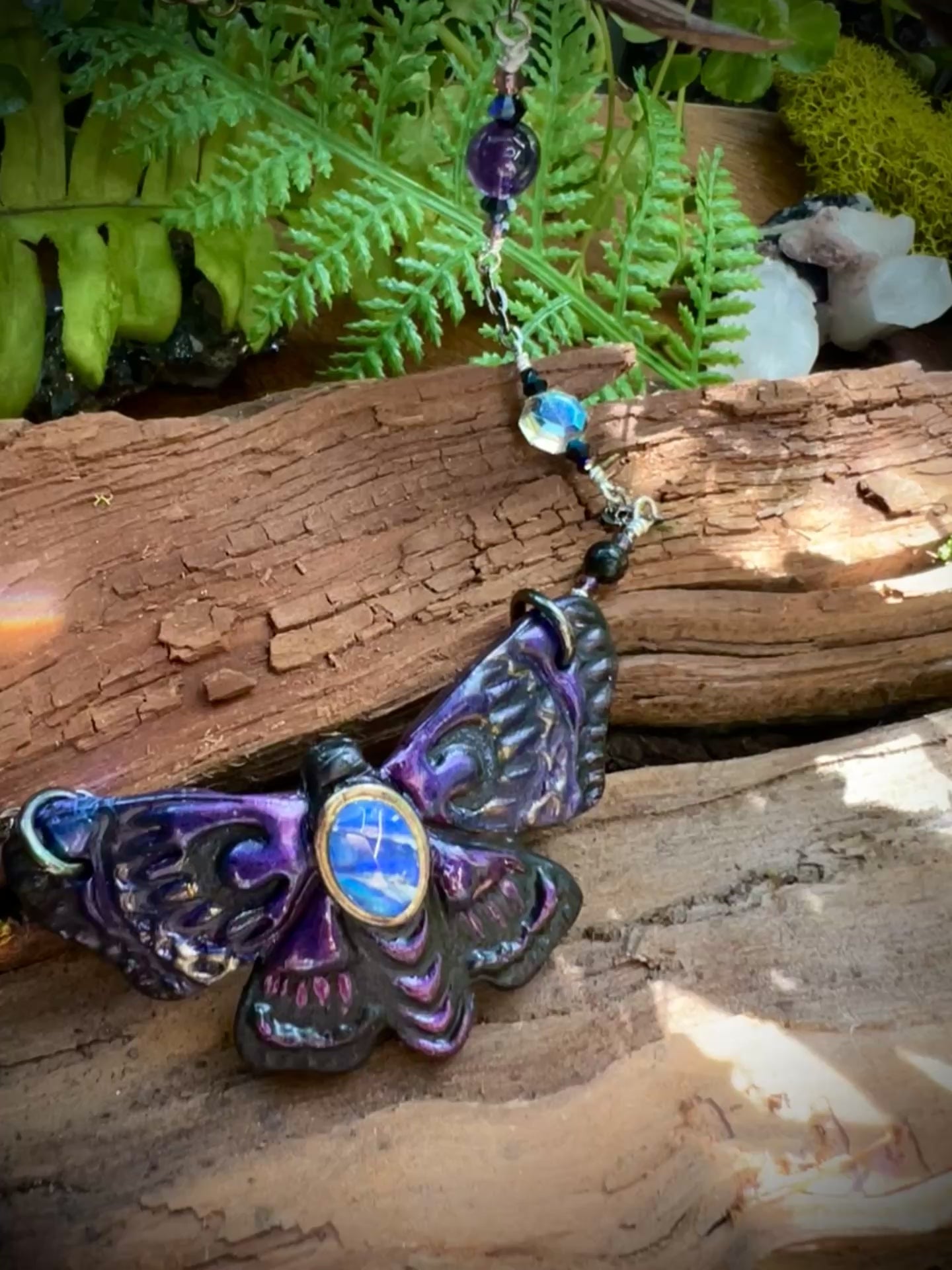 Necklace chain featuring amethyst and obsidian beads with iridescent crystal accents