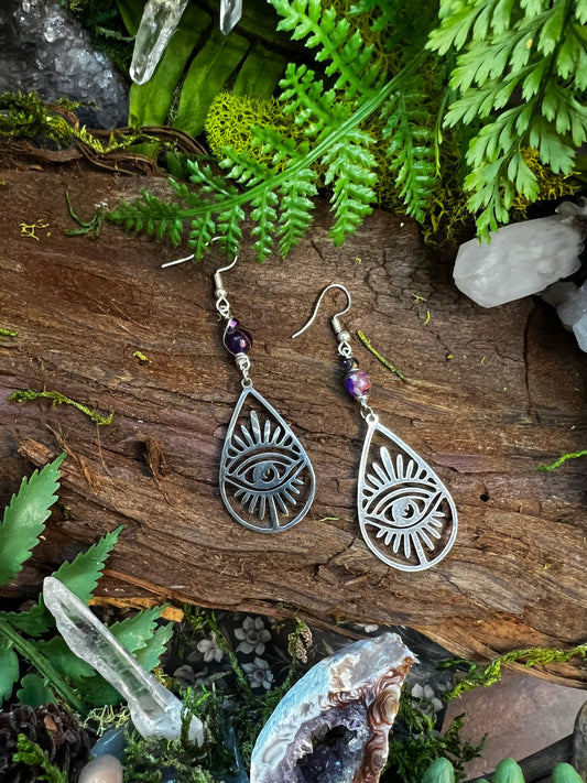Sea sediment jasper and iridescent quartz eye earrings styled on mossy wood